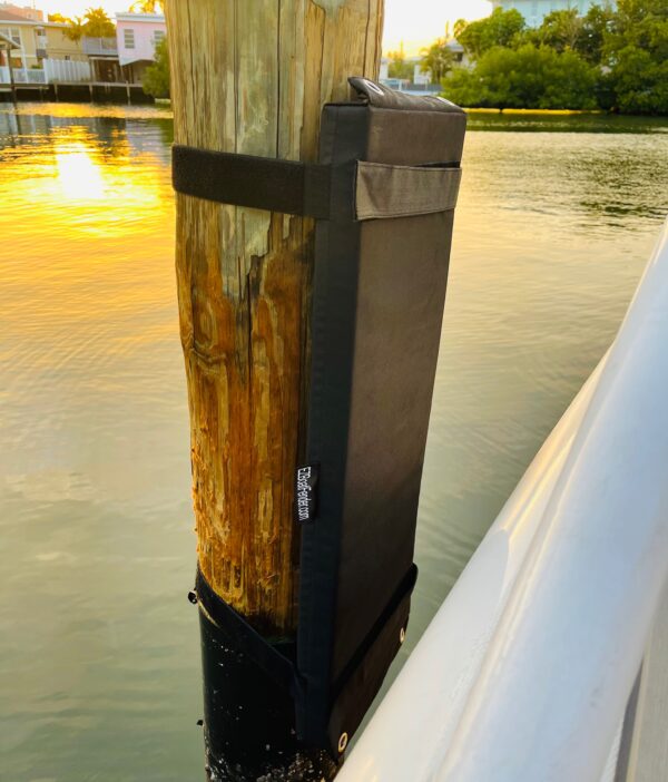 An EZ Boat Fender - Standard with a black pole and boat fenders attached to it.