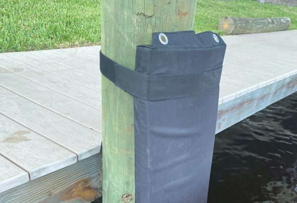 A black tarp is attached to a wooden pole.
